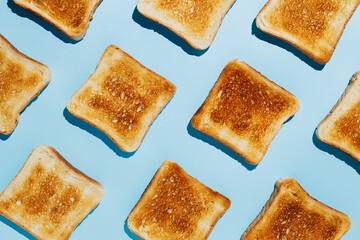 Close up pattern of French toast loaves on a bright blue contrast background. Morning breakfast...