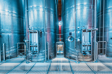 Large metal vats in which wine or beer is fermented at the factory at the winery. Concept of...