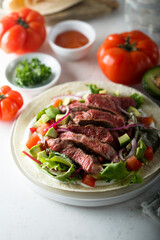 Beef steak fajitas with avocado and onion