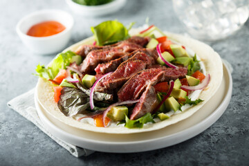 Beef steak fajitas with avocado and onion