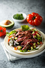Beef steak fajitas with avocado and onion