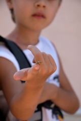 Obraz na płótnie Canvas Insect on a child's finger