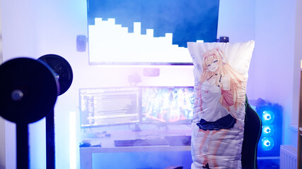 Gaming room with anime girl dakimakura body pillow surrounded with smoke