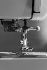sewing machine close up view with natural sunlight, slow fashion and home sewing concept in black and white