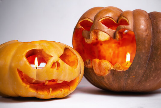 two pumpkins for halloween on a white background close-up