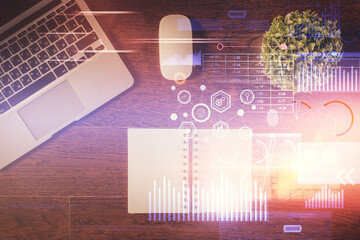 Double exposure of data theme drawing hologram over topview work table background with computer. Concept of technology.