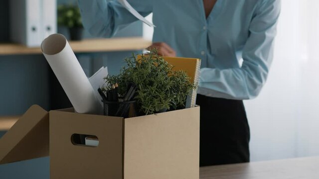 Unrecognizable Female Office Worker Packing Stuff After Dismissal Indoors, Cropped