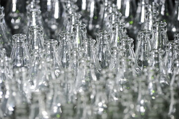 Glass bottles are on the conveyor for filling drinks