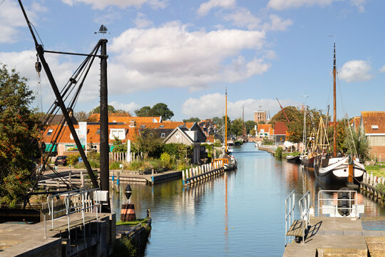 Cityscape of the city of Workum with a view of the harbor and the old tower of the Grote or Sint-Gertrudiskerk in Friesland.