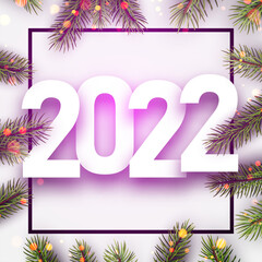 2022 Christmas green fir branches with bokeh lights.