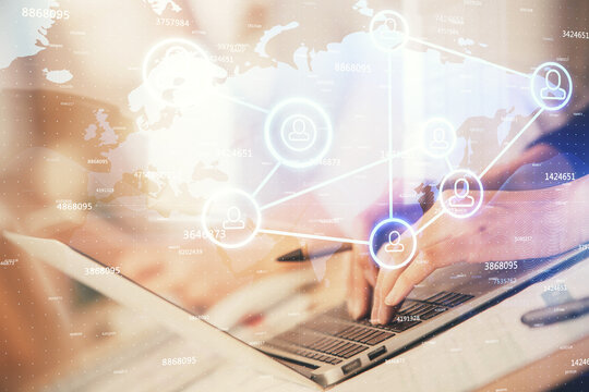 Double exposure of woman hands typing on computer and social network theme hologram drawing. People media concept.