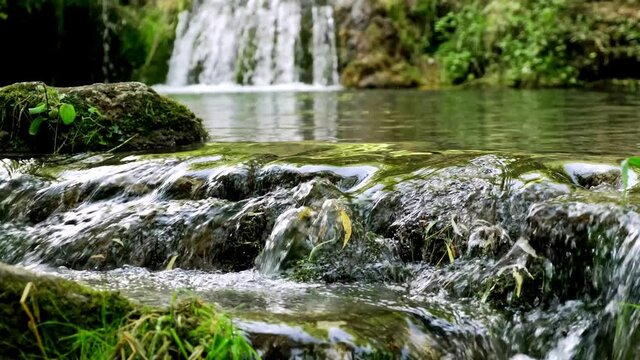 River landscape. Horizontal layout. Tropical scenery. Waterfall landscape. Beautiful hidden waterfall in rainforest. Slow shutter speed, motion photography. Nature background. Water reflection.