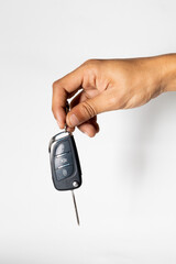 hand holding car remote isolated on white background 
