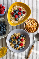 Oatmeal with berries and honey for breakfast.Beautiful healthy breakfast.Proper nutrition of the student.Catering for teens.Vegetarian 
 food.Healthy breakfast with berries.Oatmeal with berries and ho