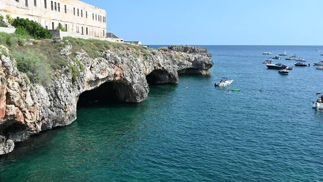 Santa maria di Leuca, Puglia, Italy. Amazing static footage of the natural caves on the coast: bathers swim in the crystal clear water to see them up close.