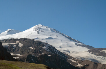 Perspective of caucasian snow mountain or volcano Elbrus. Landscape view - the highest peak of Europe