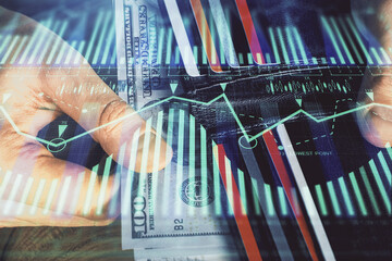 Double exposure of technology drawing hologram and us dollars bills and man hands. Data concept