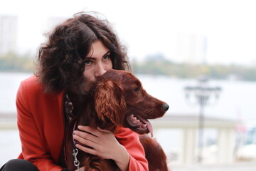 Portrait of beautiful young woman and red Irish setter