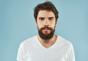 Obraz premium emotional man with a beard in a white t-shirt emotions anger