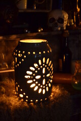 A glow-in-the-dark magic lantern on a voodoo altar. Spooky background, Halloween decoration.