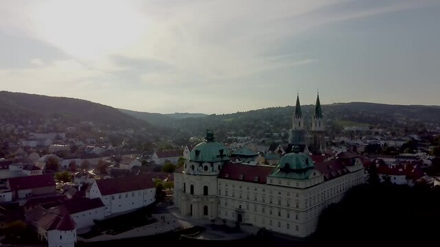 Descending flight with an Aerial view of the Klosterneuburg Monastery, Lower Austria during sunset.