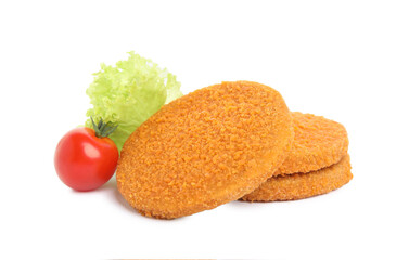 Uncooked breaded cutlets, tomato and lettuce on white background. Freshly frozen semi-finished product