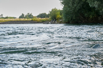 Transparent and clean mountain river with a fast current. Source of clean drinking water.