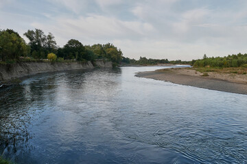 Transparent and clean mountain river with a fast current. Source of clean drinking water.