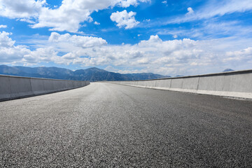 Highway ground and mountain natural scenery under blue sky.Landscape and highway.Outdoor road background.