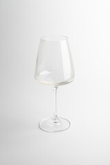 Empty transparent wine glass on the white background