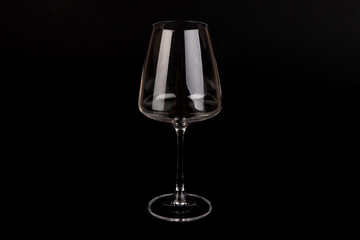 Empty transparent wine glass on the black background