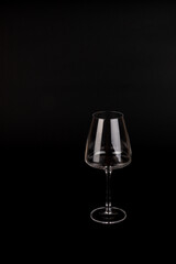 Empty transparent wine glass on the black background