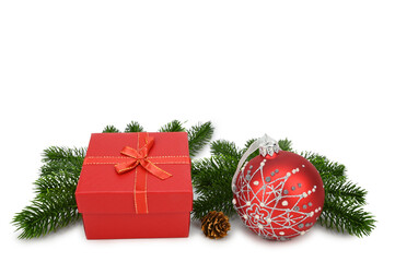 New Year's still life. Gift box, Christmas tree toy and fir branches. Isolated on white background
