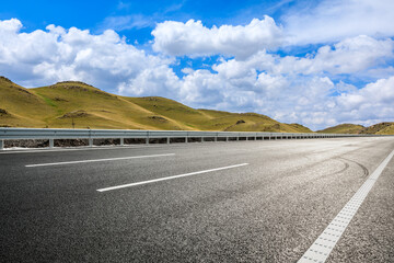 Highway ground and mountain natural scenery under blue sky.Landscape and highway.Outdoor road background.