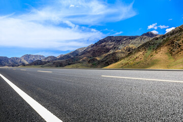 Highway ground and mountain natural scenery under blue sky.Landscape and highway.Outdoor road background.