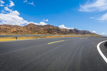Highway ground and mountain natural scenery under blue sky.Landscape and highway.Outdoor road background.