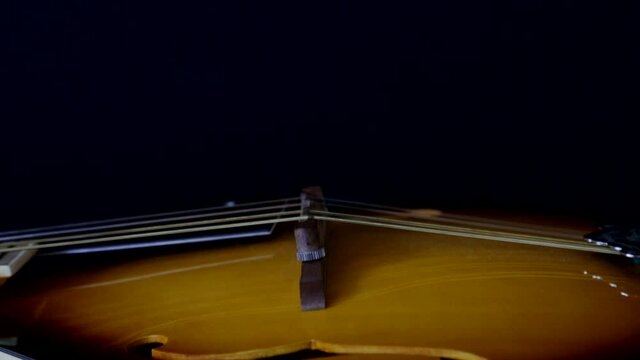 Mandolin, close camera movement on black background. Selective focus.