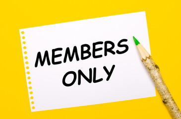 On a bright yellow background, a large wooden pencil and a white sheet of paper with the text MEMBERS ONLY