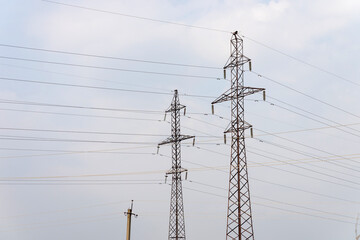 Supports high-voltage power lines against the sky. Electrical industry of Europe.