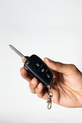 hand holding car remote isolated on white background 