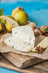 Gorgonzola picant Italian blue cheese, made from unskimmed cow's milk in North of Italy. Piece of blue mould cheese danablu,  roquefort with pear and walnuts