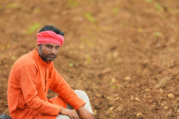 Indian farmer sitting at agriculture field