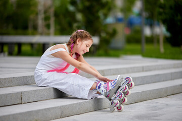 cute little girl on roller skates at park.
