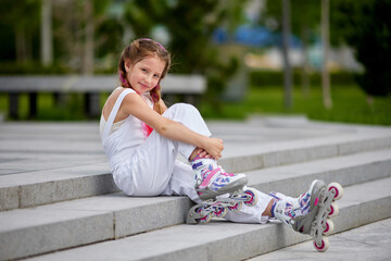 cute little girl on roller skates at park.