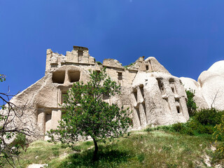 Fototapeta premium Caves carved into the rocks. Valley landscape in Cappadocia, Turkey