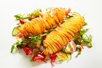 Twist potatoes and vegetable salad on white background