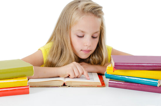 Beautiful little girl with the books. Her fingers are following the text like a newer reader. Isolated on a white background 