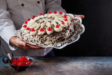 Crop cook with Black Forest cake in studio