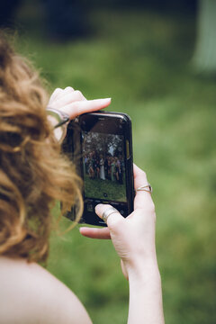 the phone screen of a woman taking a photo with her mobile phone or cell phone
