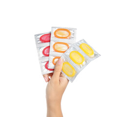 Woman holding condoms on white background, closeup